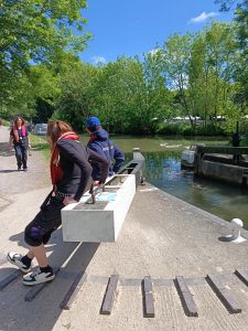 Two people are working the locks beside a canal.
